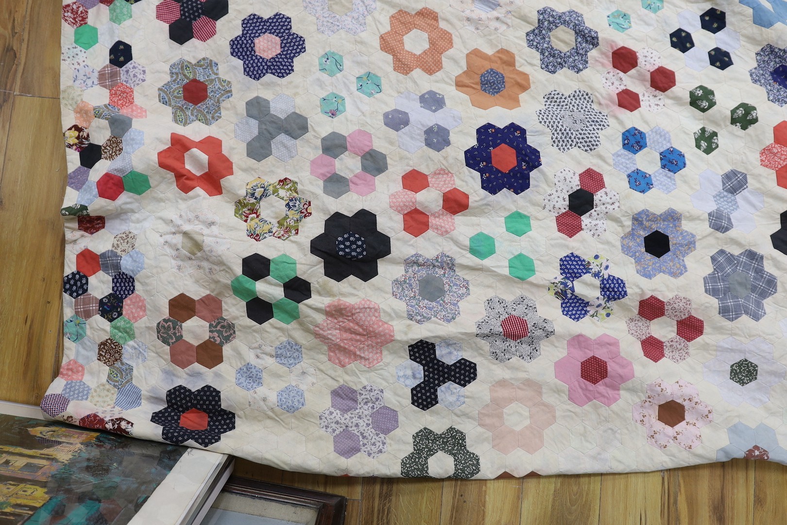 A patchwork quilt, made from Edwardian and later fabrics, 232 cms x 252cms.